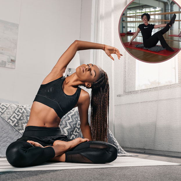 afro frau im sportoutfit macht yoga zu hause